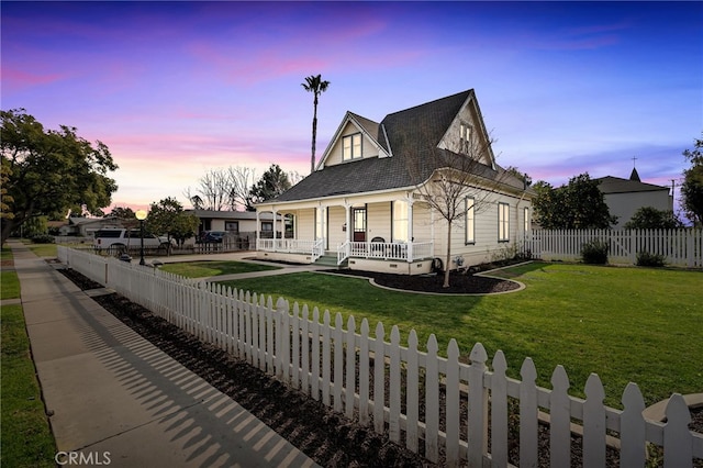 view of front of home featuring a lawn and covered porch