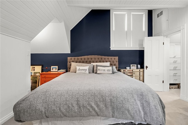 bedroom featuring carpet floors and vaulted ceiling