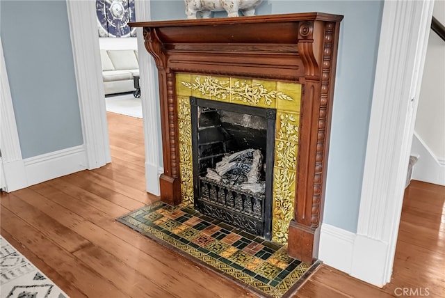 details with hardwood / wood-style floors and a fireplace