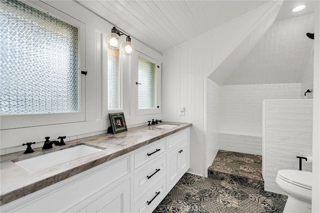 bathroom with vanity, tiled shower, tile patterned floors, and toilet