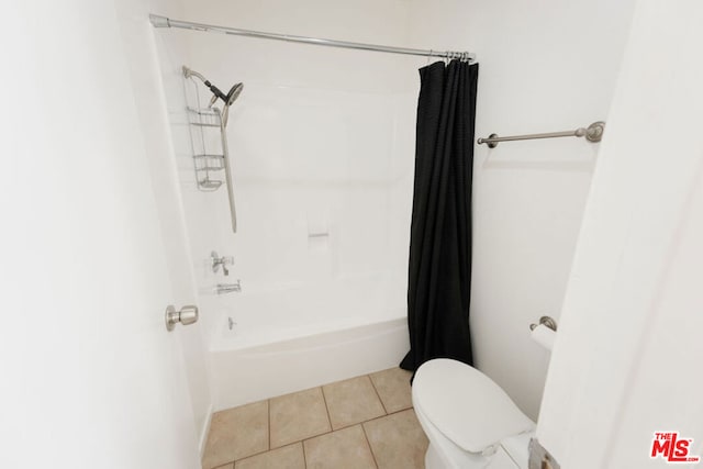 bathroom with tile patterned floors, toilet, and shower / bath combo