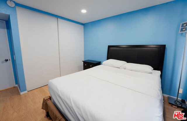 bedroom featuring a closet and light wood-type flooring