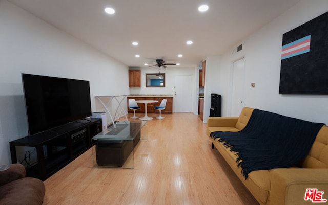 living room featuring ceiling fan and light wood-type flooring