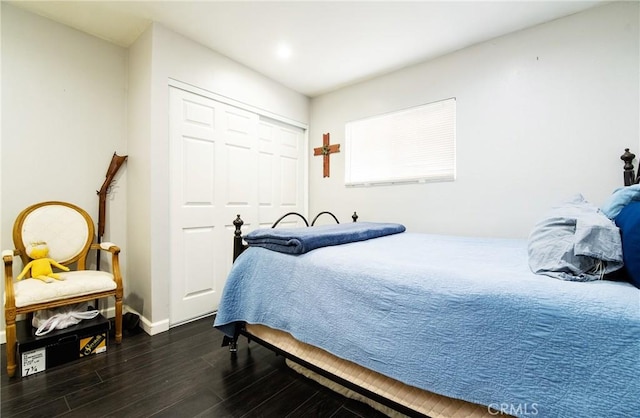 bedroom featuring dark hardwood / wood-style floors and a closet