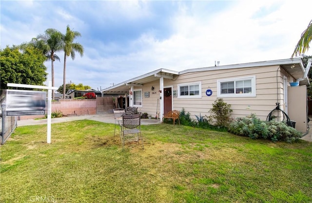 back of house featuring a yard and a patio