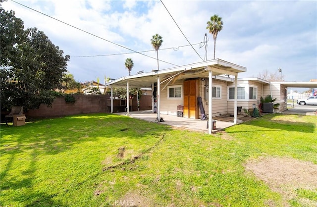 rear view of house with a yard and a patio area