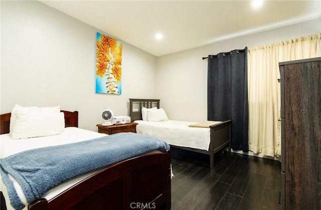 bedroom with dark wood-type flooring