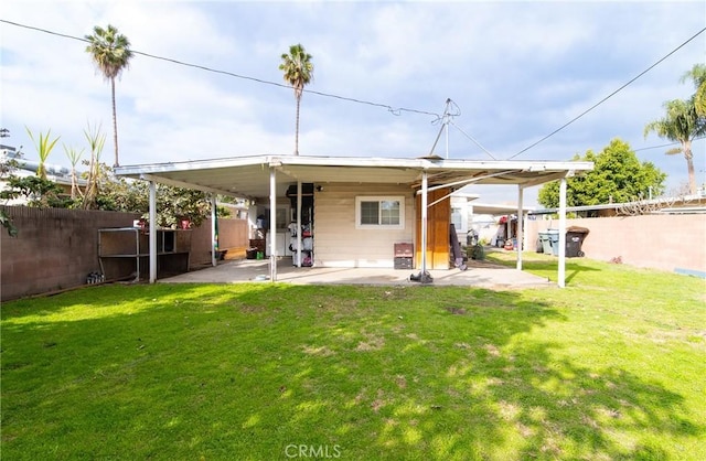 rear view of house with a patio area and a lawn