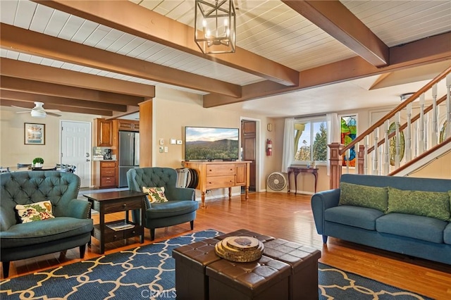 living room featuring hardwood / wood-style flooring, wooden ceiling, an inviting chandelier, and beamed ceiling