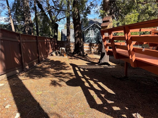 view of yard with a fenced backyard and a wooden deck