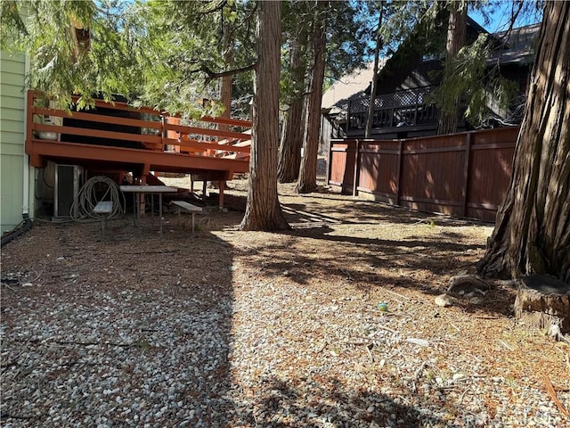 view of yard featuring fence and a deck