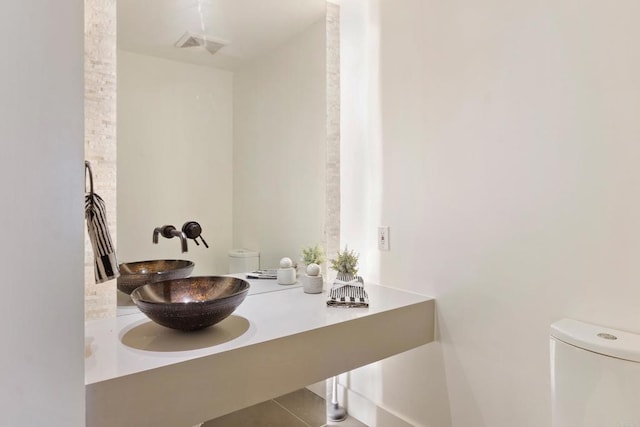 bathroom featuring tile patterned flooring, sink, and toilet