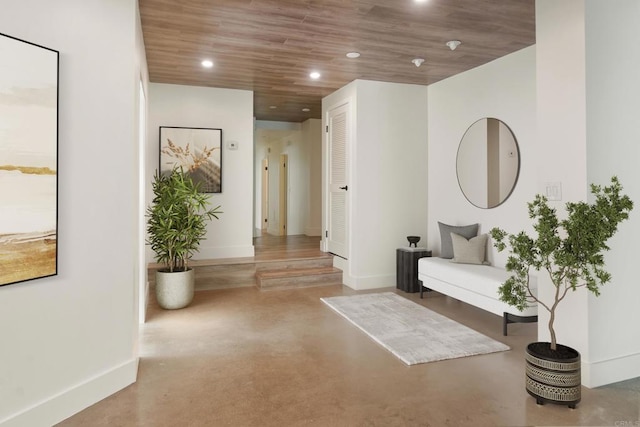 corridor with wood ceiling and concrete floors