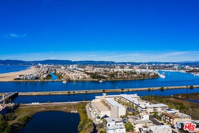 birds eye view of property with a water and mountain view