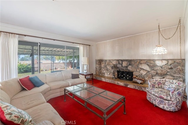 living room with crown molding and a fireplace