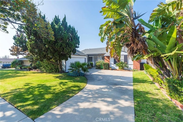 view of front of property featuring a garage and a front yard