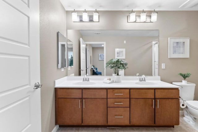 bathroom with vanity, toilet, and tile patterned flooring