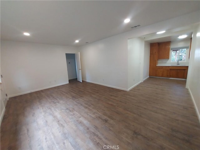 unfurnished room with wood-type flooring and sink