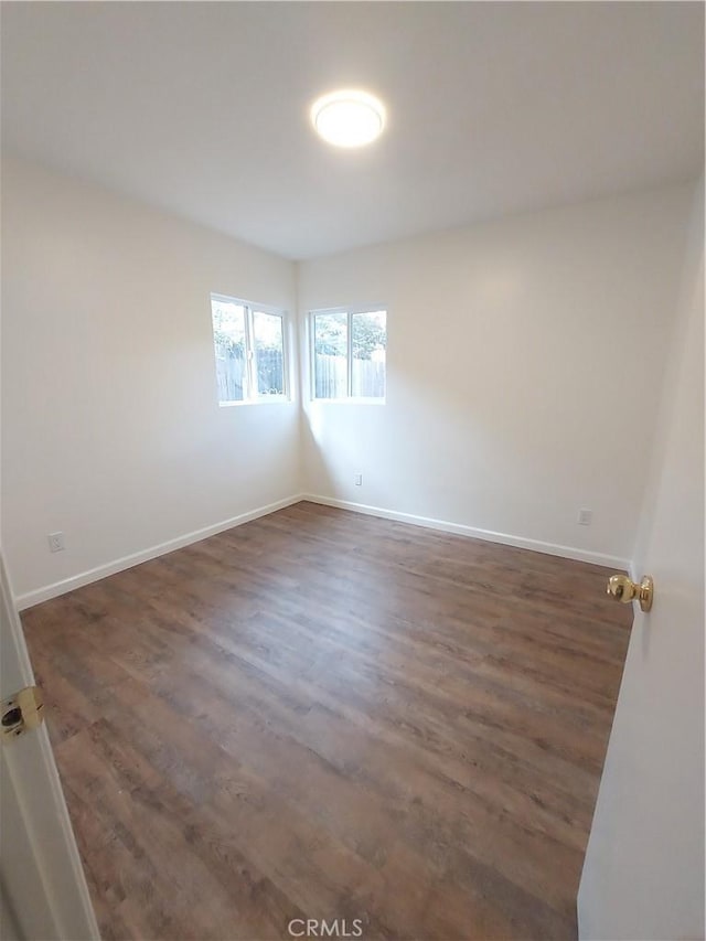 unfurnished room featuring dark hardwood / wood-style floors