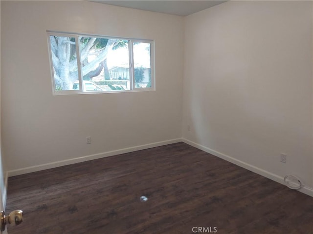 unfurnished room with dark hardwood / wood-style floors