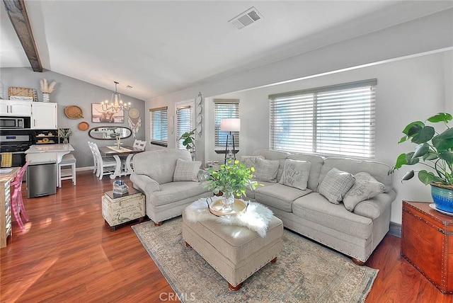 living room featuring an inviting chandelier, dark hardwood / wood-style flooring, and vaulted ceiling with beams