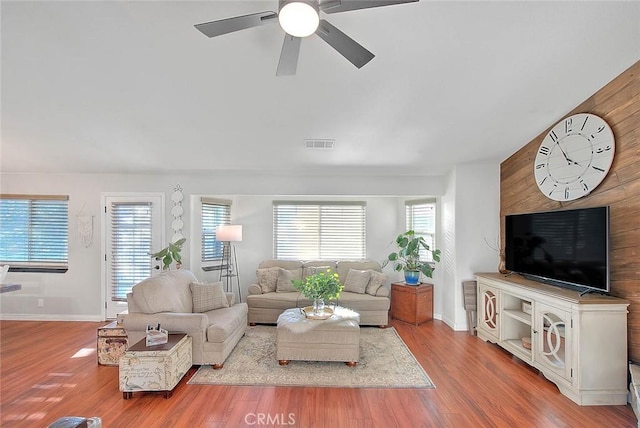 living room featuring ceiling fan and light wood-type flooring