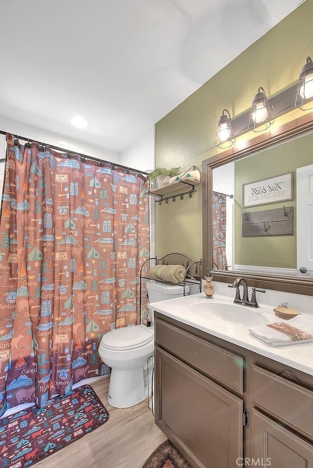 bathroom with vanity, hardwood / wood-style floors, and toilet