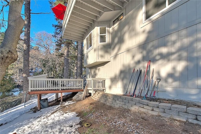 snow covered property featuring a wooden deck