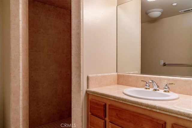 bathroom featuring vanity and a tile shower