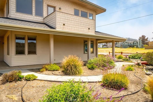 back of property with covered porch