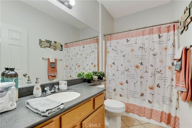 bathroom with vanity, toilet, and tile patterned flooring