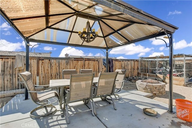 view of patio featuring a gazebo and a fire pit