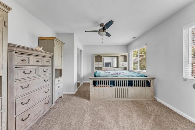 unfurnished bedroom featuring ceiling fan and light carpet