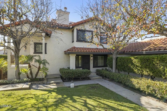 mediterranean / spanish-style house with a front lawn