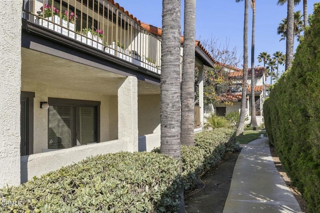 view of side of home featuring a balcony