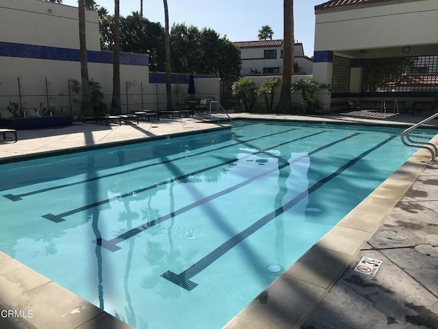 view of swimming pool featuring a patio