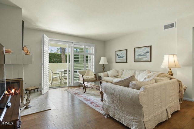 living room with dark hardwood / wood-style flooring