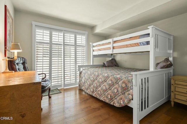 bedroom with dark wood-type flooring