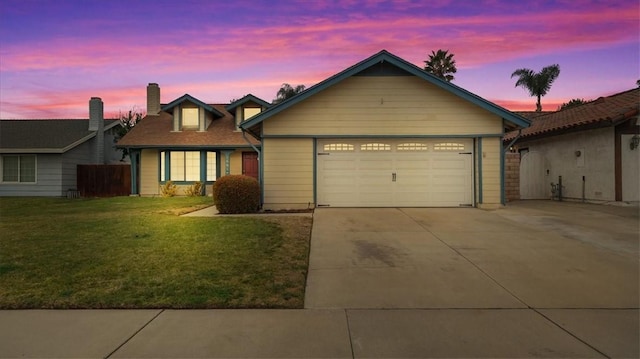 view of front facade with a garage and a yard