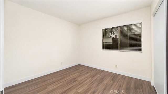 spare room with dark hardwood / wood-style floors