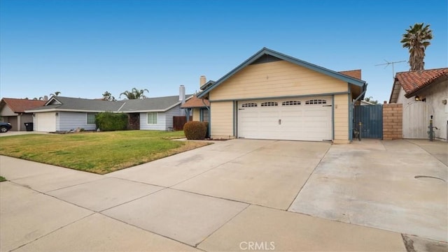 ranch-style home with a garage and a front lawn