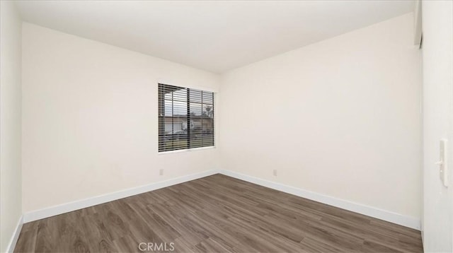 spare room featuring dark wood-type flooring