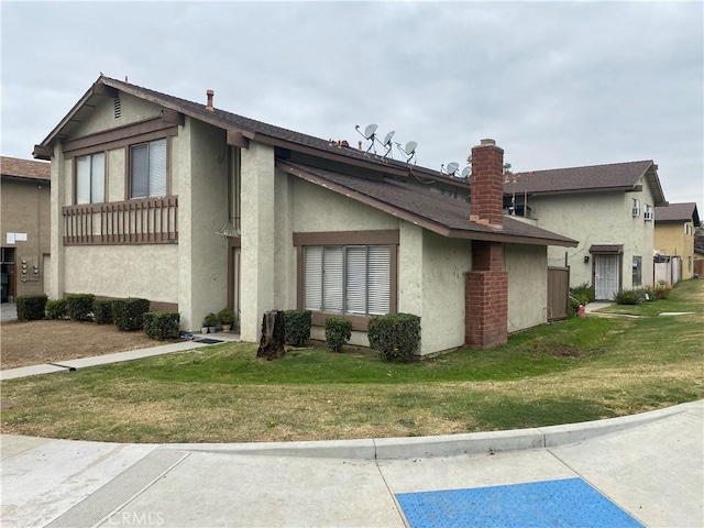 view of side of property with a lawn