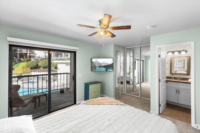 bedroom with sink, ensuite bath, light carpet, ceiling fan, and access to exterior