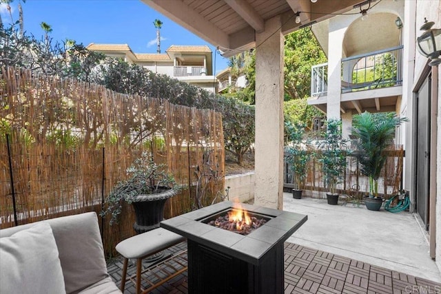 view of patio / terrace with ceiling fan and an outdoor fire pit