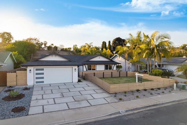 single story home featuring a garage and a front lawn