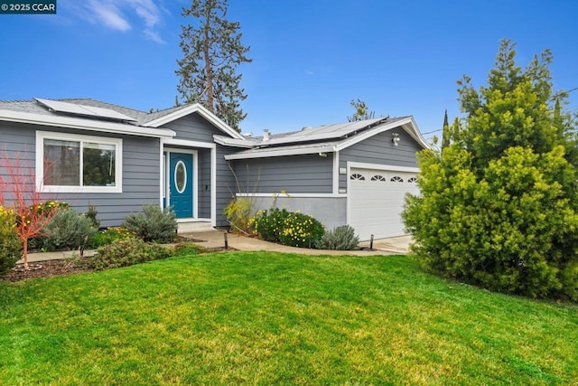 single story home with a garage, a front yard, and solar panels