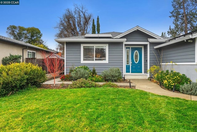 bungalow-style house with a front lawn