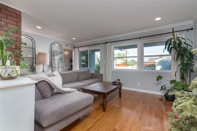 living room with ornamental molding and light hardwood / wood-style floors