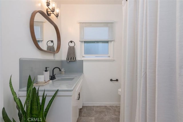 bathroom featuring vanity and backsplash